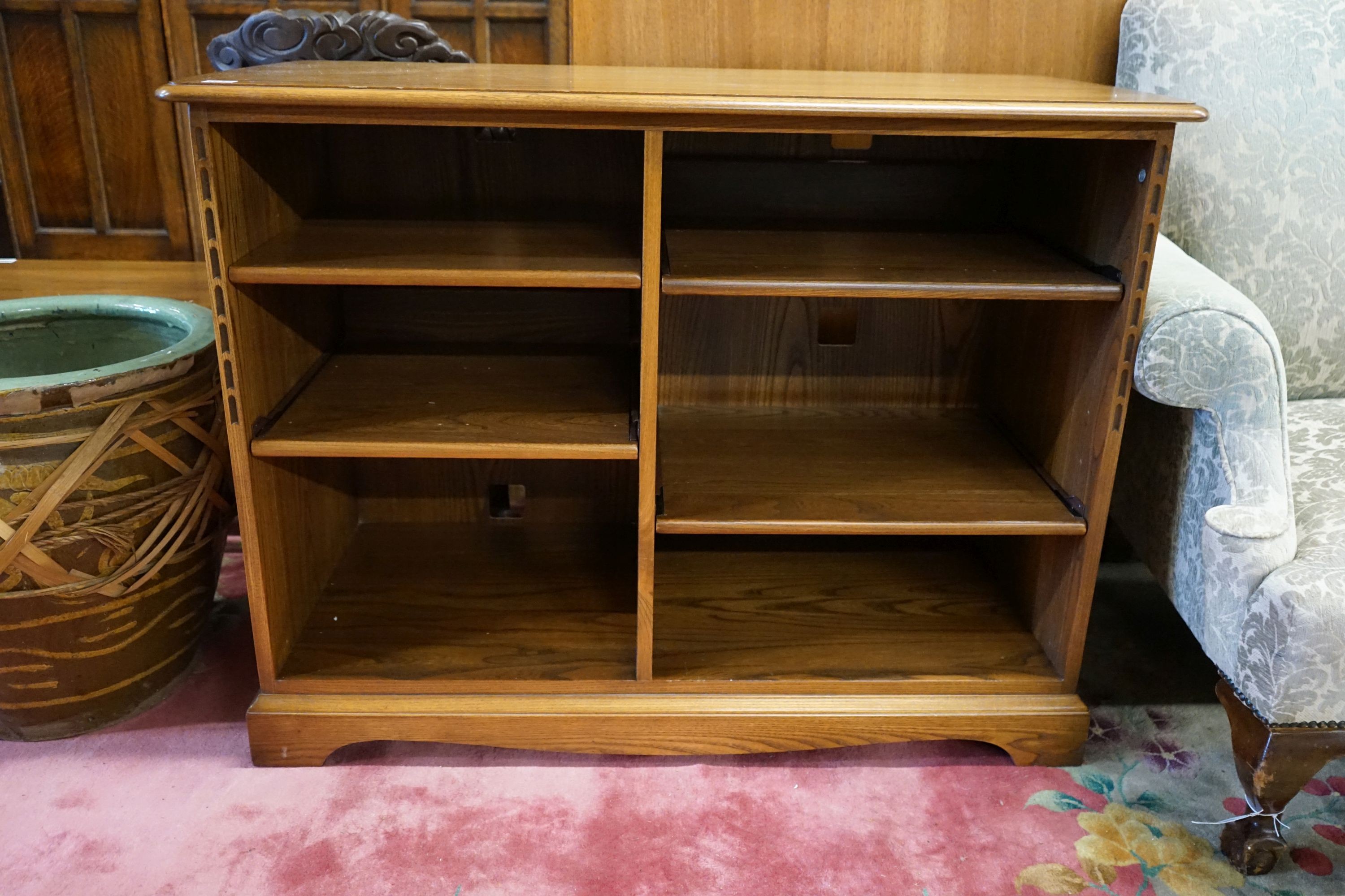 An Ercol elm open media unit, width 110cm, depth 52cm, height 82cm